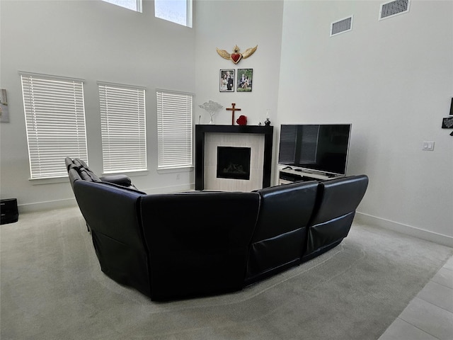 2856 Chester Dr, Celina, TX 75009 - living room featuring baseboards, visible vents, a high ceiling, and a tile fireplace