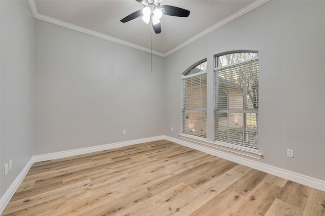 unfurnished room with wood finished floors, crown molding, baseboards, and ceiling fan