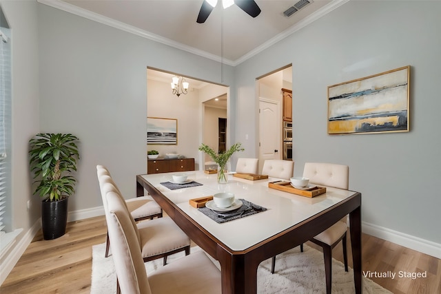 dining room with baseboards, light wood-style flooring, and visible vents