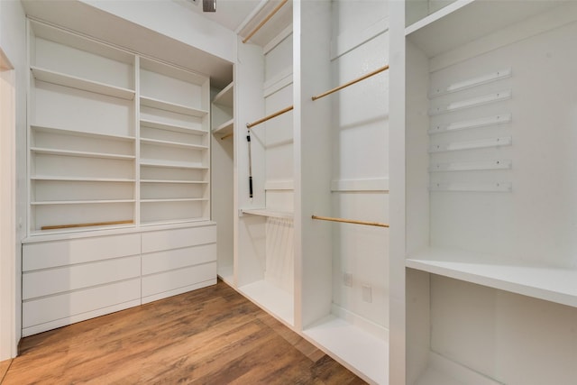 walk in closet featuring wood finished floors