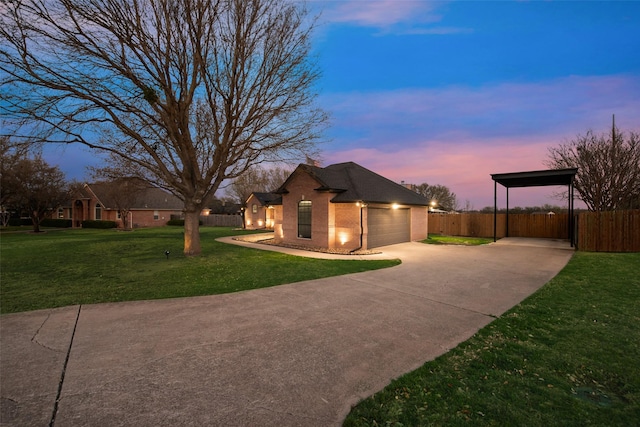 view of home's exterior featuring fence, concrete driveway, a carport, a lawn, and brick siding