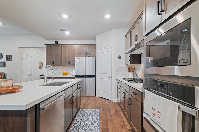 113 Glenwood Dr, Oak Point, TX 75068 - kitchen featuring stainless steel appliances, wood finished floors, backsplash, light countertops, and recessed lighting