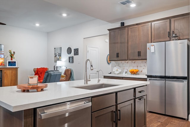113 Glenwood Dr, Oak Point, TX 75068 - kitchen featuring stainless steel appliances, a center island with sink, light countertops, light wood-style flooring, and recessed lighting
