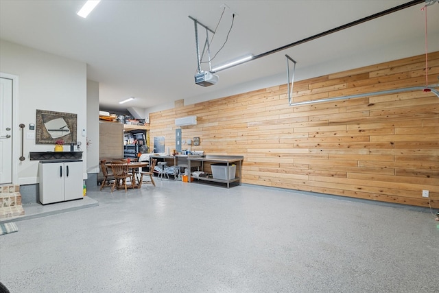 113 Glenwood Dr, Oak Point, TX 75068 - garage with wood walls and a garage door opener
