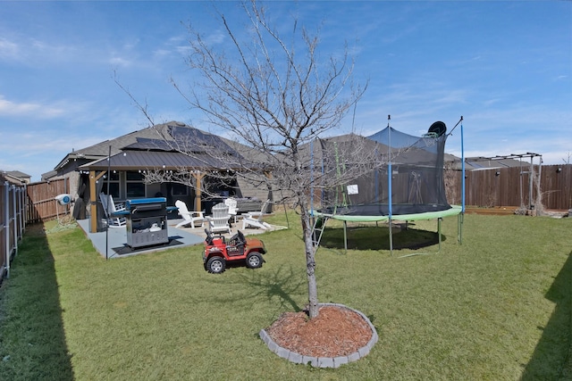 808 Glover Dr, Aubrey, TX 76227 - view of yard featuring a fenced backyard, a trampoline, a gazebo, and a patio