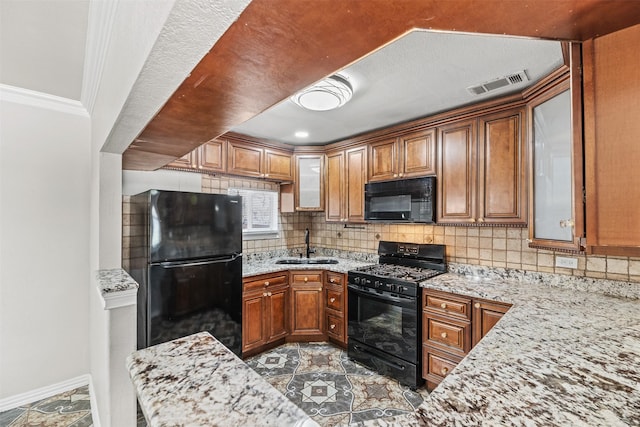 4512 Fletcher Ave, Fort Worth, TX 76107 - kitchen with visible vents, backsplash, black appliances, and a sink