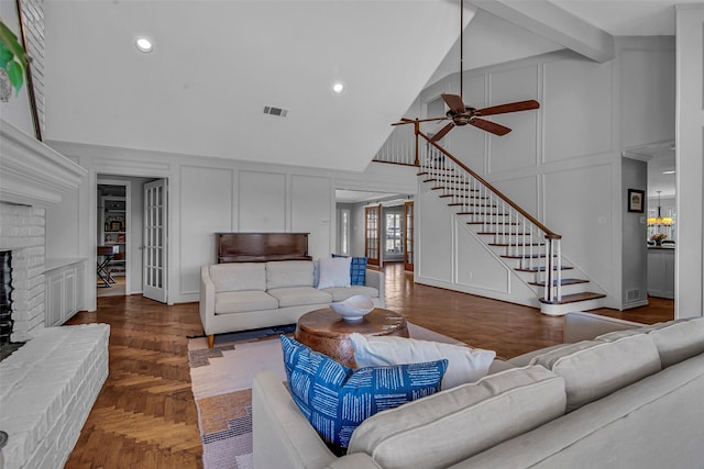 9702 Trail Hill Dr, Dallas, TX 75238 - living room featuring a fireplace, stairway, a decorative wall, and a ceiling fan