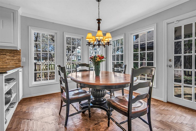 9702 Trail Hill Dr, Dallas, TX 75238 - dining space featuring a chandelier, crown molding, and baseboards