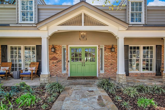 9702 Trail Hill Dr, Dallas, TX 75238 - view of exterior entry with brick siding and a porch
