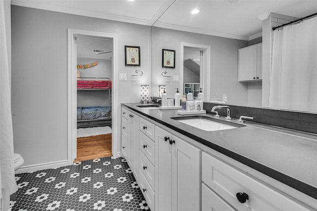 9702 Trail Hill Dr, Dallas, TX 75238 - full bathroom featuring toilet, a sink, recessed lighting, crown molding, and double vanity