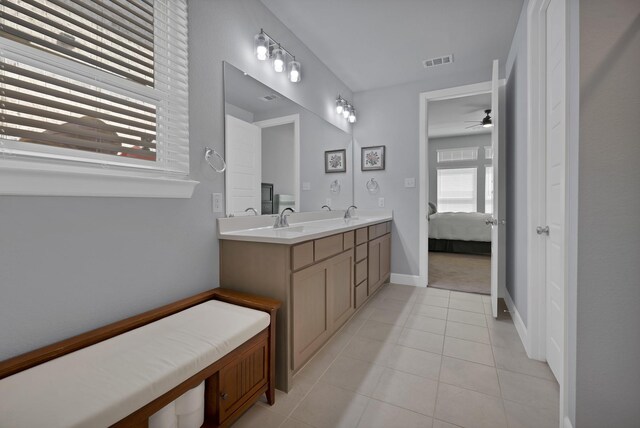 bathroom with double vanity, visible vents, ensuite bathroom, a ceiling fan, and tile patterned flooring