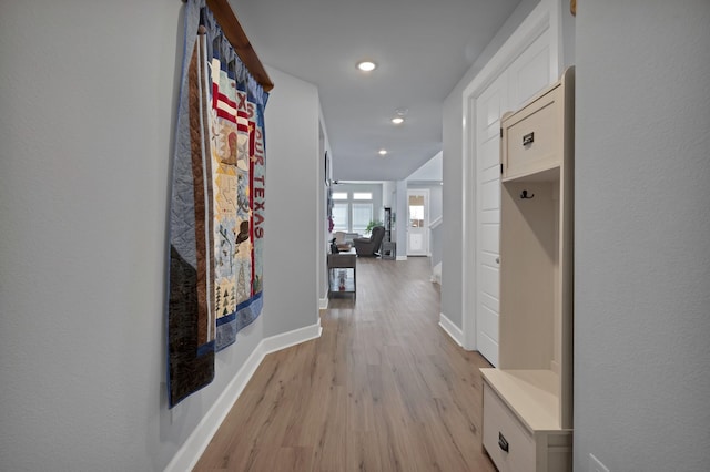 hall with light wood-type flooring, recessed lighting, and baseboards