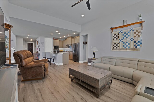 living area featuring a ceiling fan, light wood-style flooring, recessed lighting, and baseboards