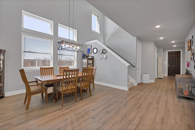 dining room with baseboards, recessed lighting, stairway, and light wood-style floors
