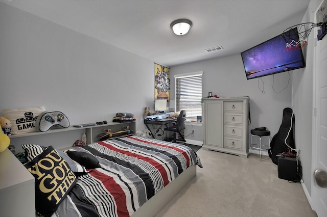 bedroom with visible vents, light colored carpet, and baseboards
