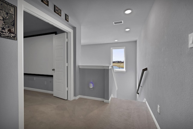 hall featuring carpet flooring, an upstairs landing, visible vents, baseboards, and recessed lighting