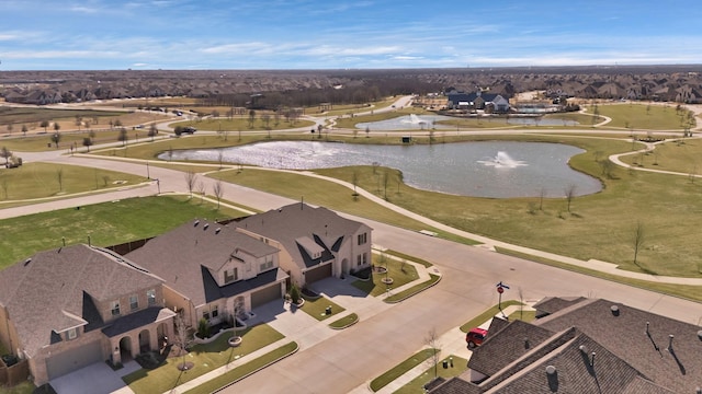 drone / aerial view with a residential view and a water view