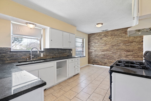 7918 Racine Dr, Dallas, TX 75232 - kitchen featuring visible vents, a sink, open shelves, under cabinet range hood, and dark countertops