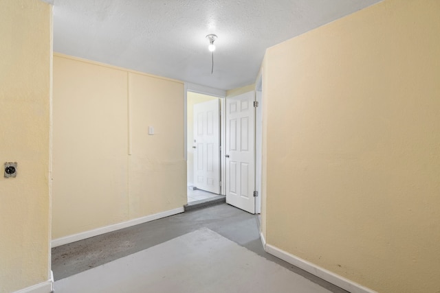 7918 Racine Dr, Dallas, TX 75232 - interior space with baseboards, a textured ceiling, and concrete floors