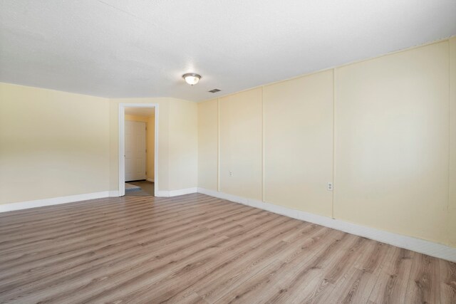7918 Racine Dr, Dallas, TX 75232 - empty room with light wood-style flooring, visible vents, and baseboards