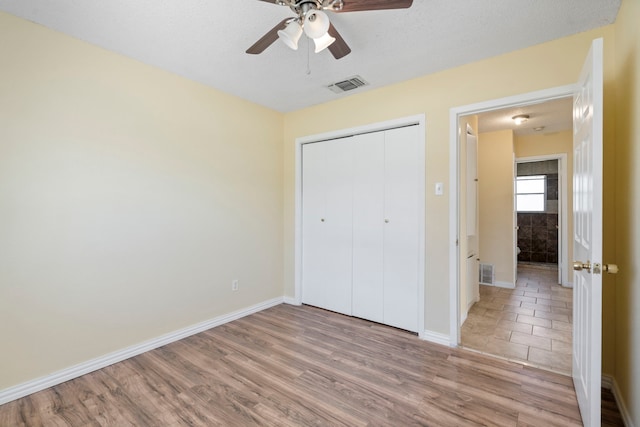 7918 Racine Dr, Dallas, TX 75232 - unfurnished bedroom featuring a closet, baseboards, visible vents, and light wood finished floors