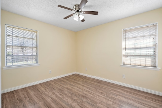 7918 Racine Dr, Dallas, TX 75232 - unfurnished room with a ceiling fan, wood finished floors, baseboards, and a wealth of natural light