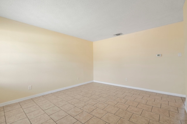 7918 Racine Dr, Dallas, TX 75232 - spare room with baseboards, visible vents, and a textured ceiling