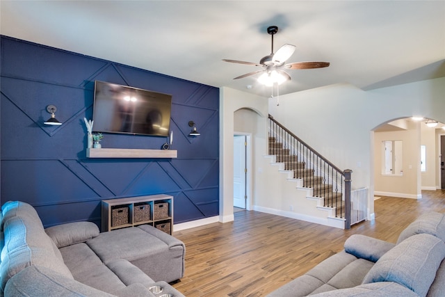 632 Ridgewater Trl, Fort Worth, TX 76131 - living area featuring stairs, wood finished floors, a ceiling fan, and arched walkways