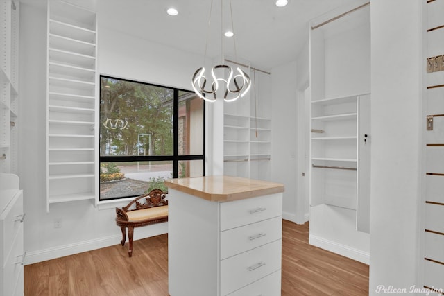 1756 Willow Point Dr, Shreveport, LA 71119 - walk in closet with light wood-style floors and a chandelier