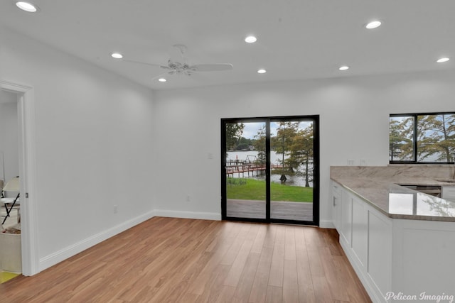 1756 Willow Point Dr, Shreveport, LA 71119 - unfurnished dining area featuring recessed lighting, healthy amount of natural light, light wood finished floors, ceiling fan, and a water view