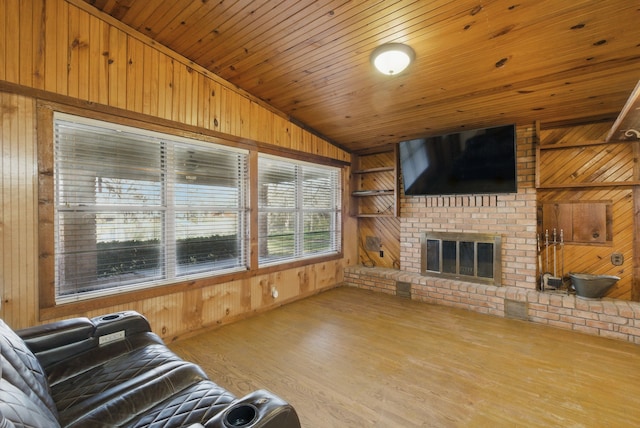 living room featuring wood walls, built in shelves, wooden ceiling, and wood finished floors