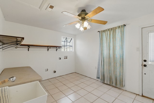 laundry area featuring light tile patterned floors, visible vents, laundry area, a sink, and washer hookup