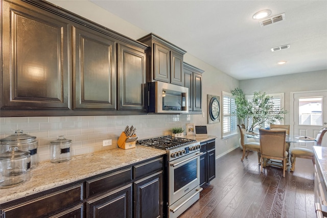 108 Oakmont Dr, Argyle, TX 76226 - kitchen with decorative backsplash, dark wood-style floors, visible vents, and stainless steel appliances