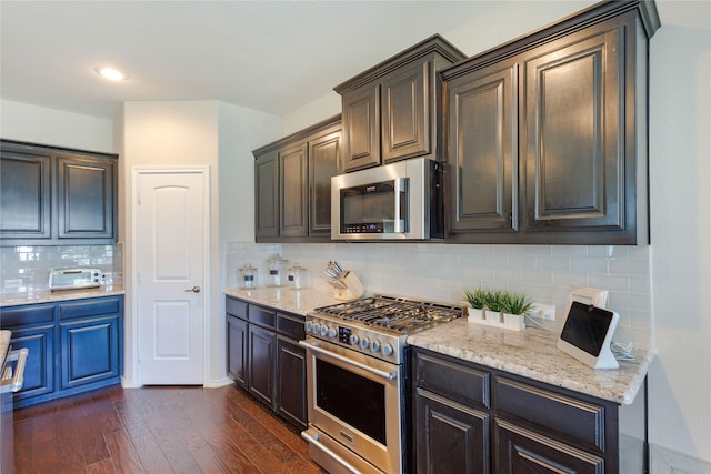 108 Oakmont Dr, Argyle, TX 76226 - kitchen featuring stainless steel appliances, light stone countertops, backsplash, and dark wood-style floors