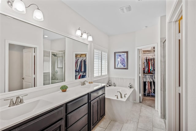 108 Oakmont Dr, Argyle, TX 76226 - bathroom featuring a spacious closet, a shower stall, a garden tub, and a sink