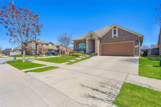 108 Oakmont Dr, Argyle, TX 76226 - view of front facade with a residential view, concrete driveway, a front yard, a garage, and brick siding