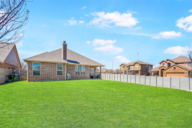108 Oakmont Dr, Argyle, TX 76226 - rear view of property featuring brick siding, a fenced backyard, a chimney, and a yard