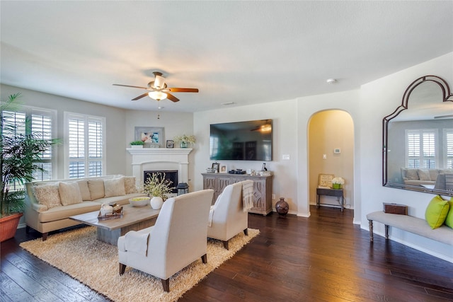 108 Oakmont Dr, Argyle, TX 76226 - living area with dark wood-style floors, arched walkways, and a healthy amount of sunlight