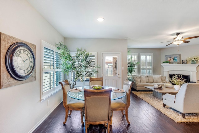 108 Oakmont Dr, Argyle, TX 76226 - dining room with baseboards, dark wood finished floors, a lit fireplace, recessed lighting, and a ceiling fan