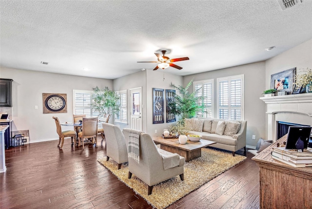 108 Oakmont Dr, Argyle, TX 76226 - living area with dark wood-style floors, visible vents, a healthy amount of sunlight, and a ceiling fan