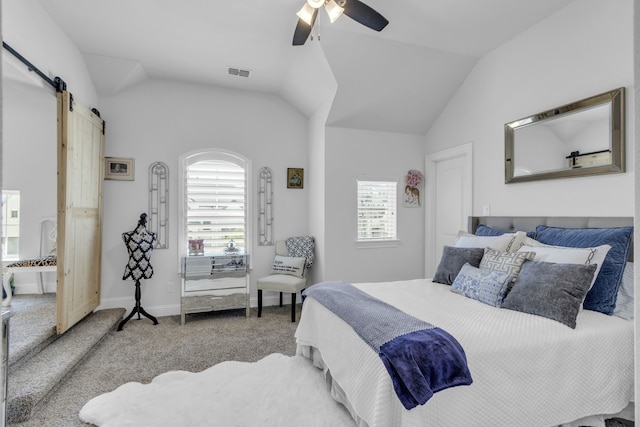 2860 Bluegill Ln, Prosper, TX 75078 - carpeted bedroom with a barn door, multiple windows, a ceiling fan, lofted ceiling, and baseboards