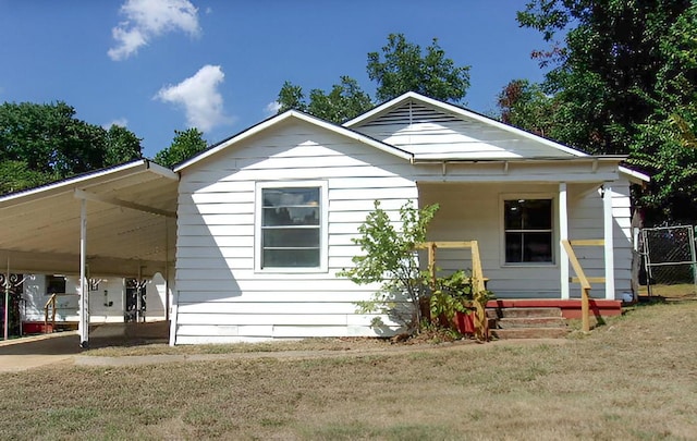 711 Dubois St, Denison, TX 75020 - view of front facade with an attached carport, covered porch, and a front yard