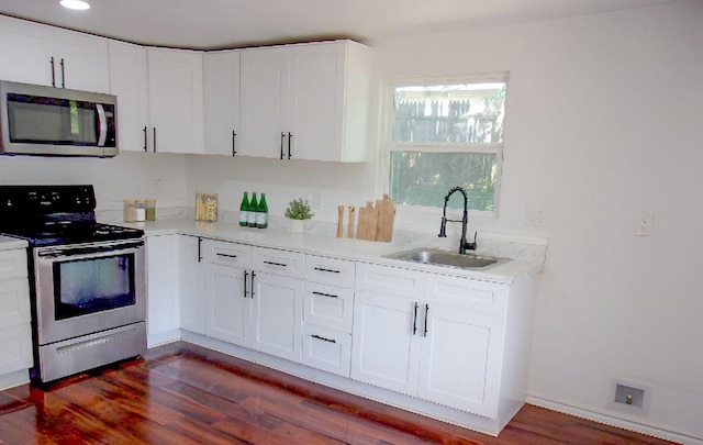 711 Dubois St, Denison, TX 75020 - kitchen with white cabinetry, light countertops, appliances with stainless steel finishes, and a sink