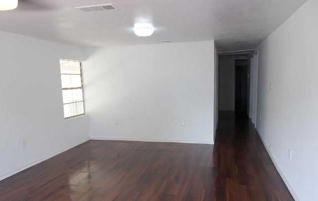 711 Dubois St, Denison, TX 75020 - spare room featuring wood finished floors, visible vents, and baseboards