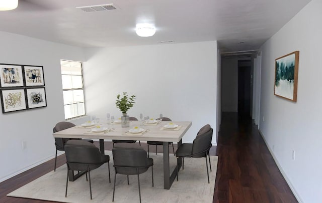 711 Dubois St, Denison, TX 75020 - dining room with visible vents, baseboards, and wood finished floors