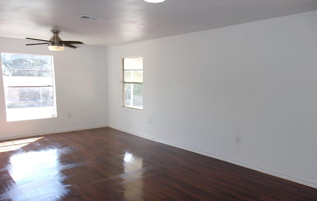 711 Dubois St, Denison, TX 75020 - empty room featuring visible vents, baseboards, ceiling fan, and wood finished floors