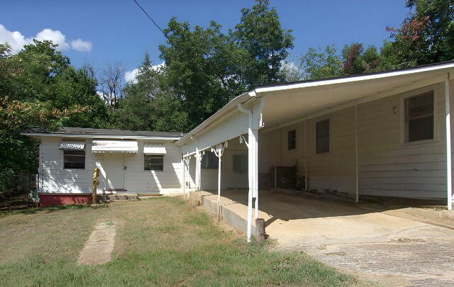 711 Dubois St, Denison, TX 75020 - back of property with a carport and a lawn