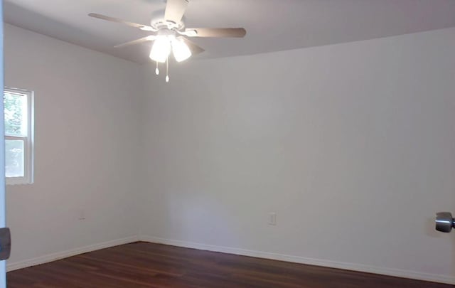 711 Dubois St, Denison, TX 75020 - unfurnished room featuring baseboards, dark wood-style flooring, and a ceiling fan
