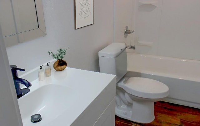 711 Dubois St, Denison, TX 75020 - full bath with vanity, toilet, wood finished floors, and shower / washtub combination