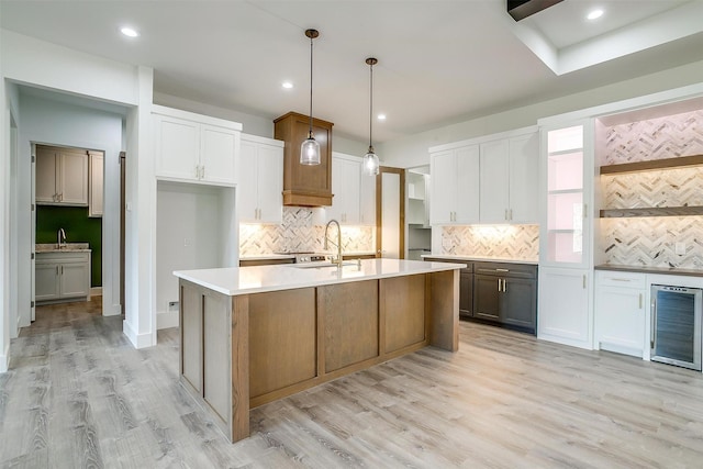 224 Ash Creek Dr W, Azle, TX 76020 - kitchen featuring white cabinetry, light countertops, decorative light fixtures, and wine cooler